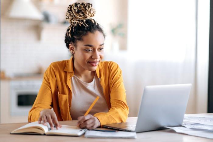 Focused cute stylish african american female student with afro